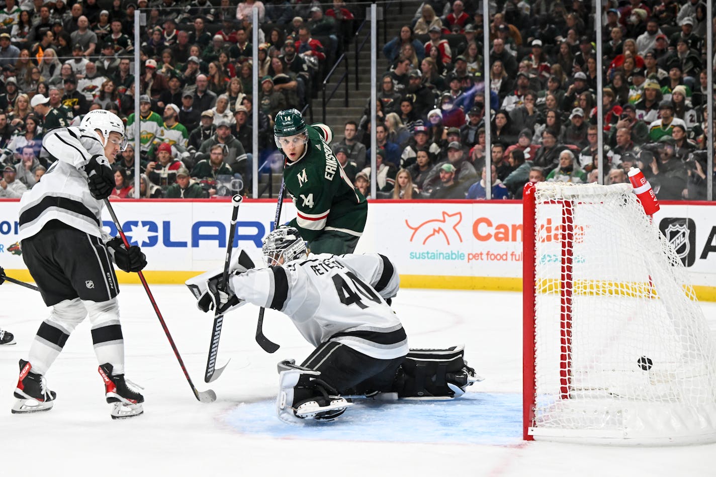 A shot by Minnesota Wild right wing Mats Zuccarello (36), not pictured, makes it past Los Angeles Kings goaltender Cal Petersen (40) for a goal with Minnesota Wild center Joel Eriksson Ek (14) eyeing the puck during the third period Saturday, Oct. 15, 2022 at the Xcel Energy Center in St. Paul, Minn.. ] aaron.lavinsky@startribune.com