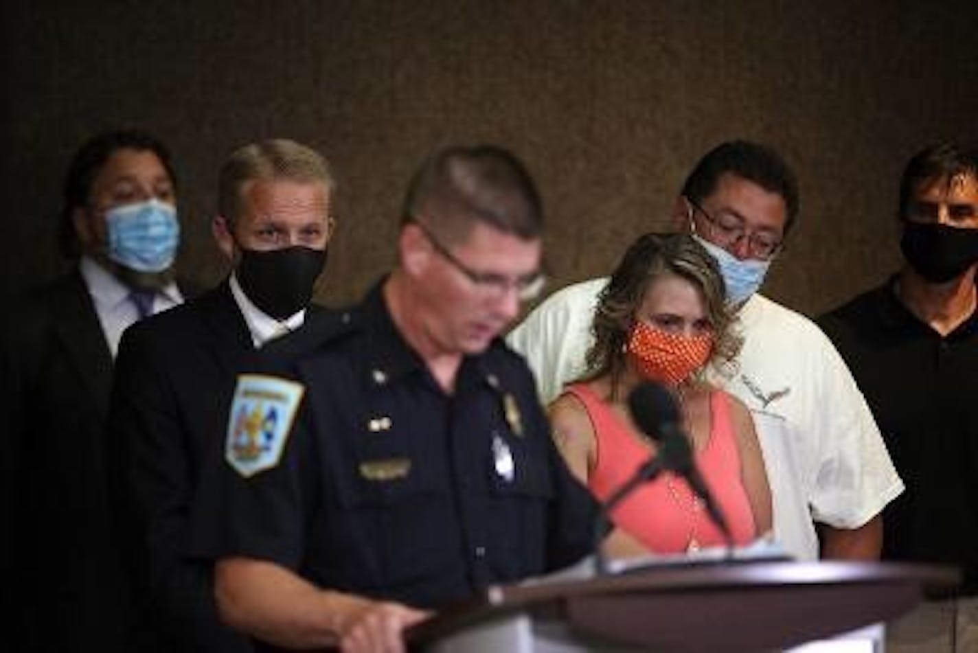 Chisholm Police Chief Vern Manner reads remarks from Nancy Daugherty's daughter, Gina Haggard (right), joined by her husband Dave Haggard, as BCA Superintendent Drew Evans (left) looks on. Chisholm police and the BCA announced on Wednesday night the arrest of a suspect in the 34-year-old murder of Daugherty.