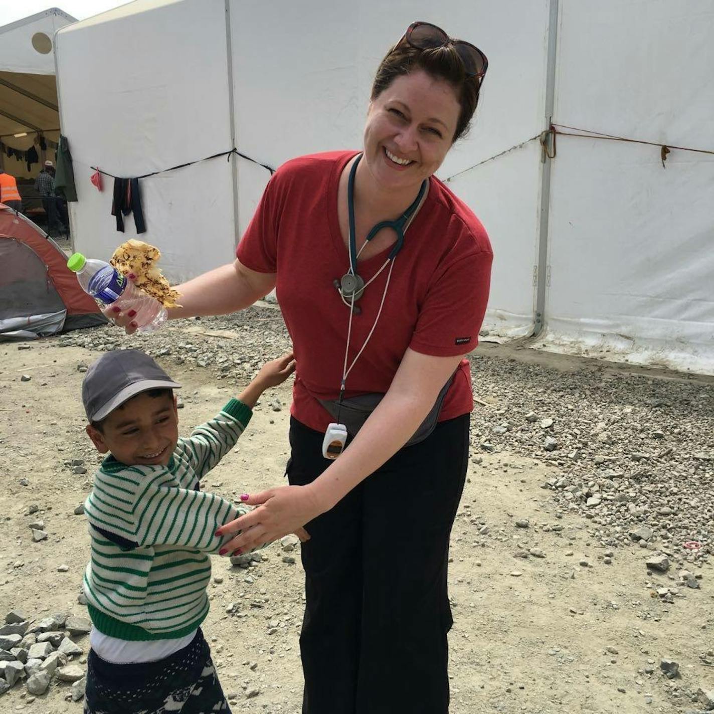 Lindsey Smith and a boy at a refugee camp on the border of Greece and Macedonia in 2016.