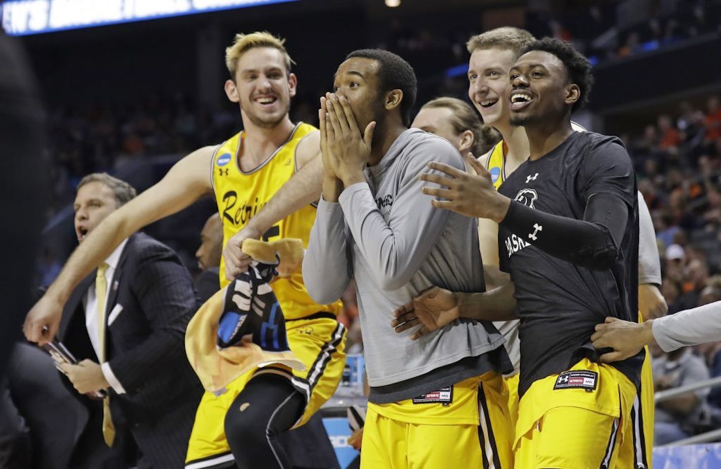 UMBC players celebrate a teammate's basket against Virginia during the second half of a first-round game in the NCAA men's college basketball tournament in Charlotte, N.C., Friday, March 16, 2018.