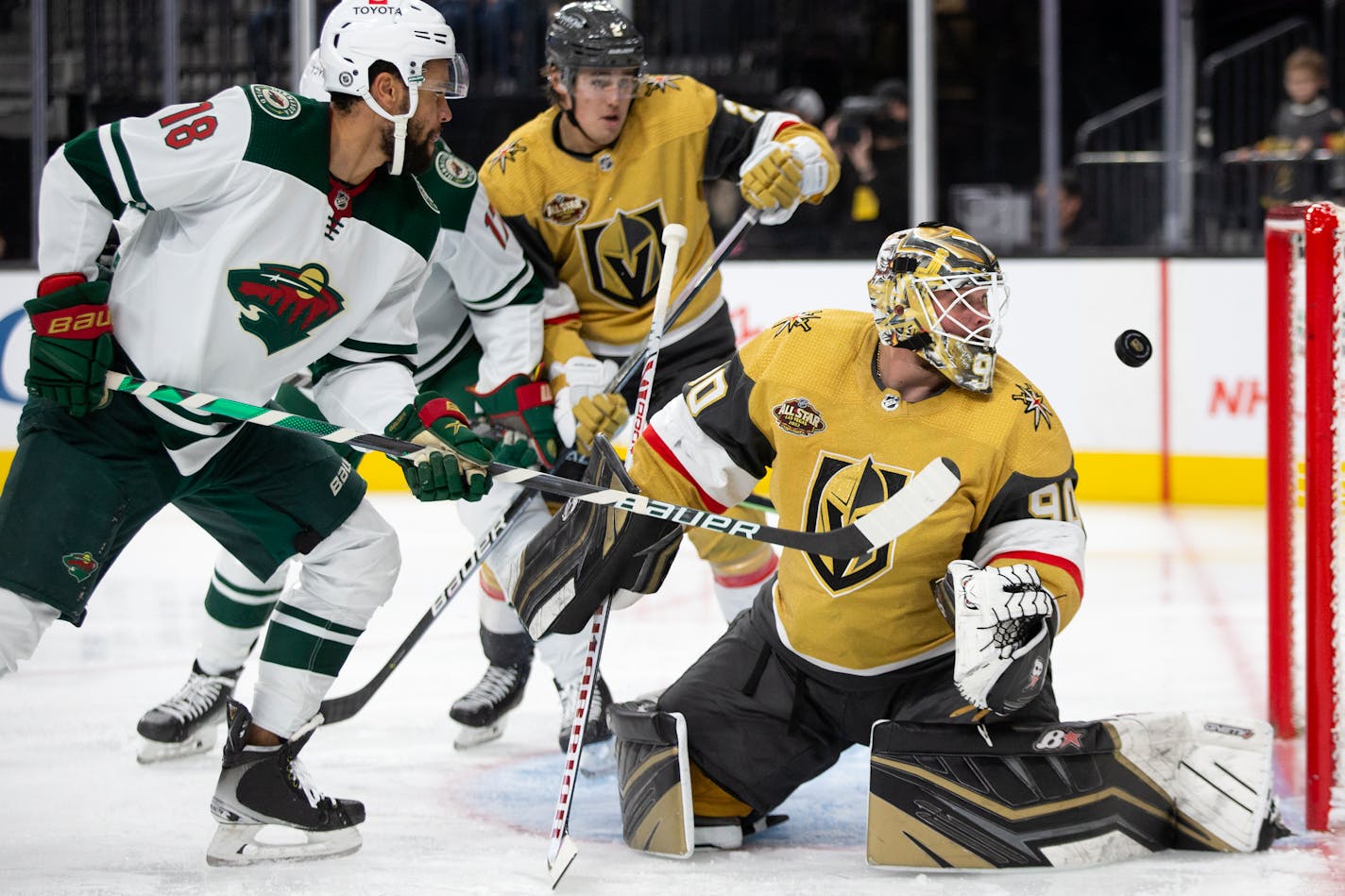 Minnesota Wild left wing Jordan Greenway (18) watches as a shot by left wing Marcus Foligno (17) scores a goal on Vegas Golden Knights goaltender Robin Lehner (90) during the third period of an NHL hockey game Sunday, Dec. 12, 2021, in Las Vegas. (AP Photo/Ellen Schmidt)