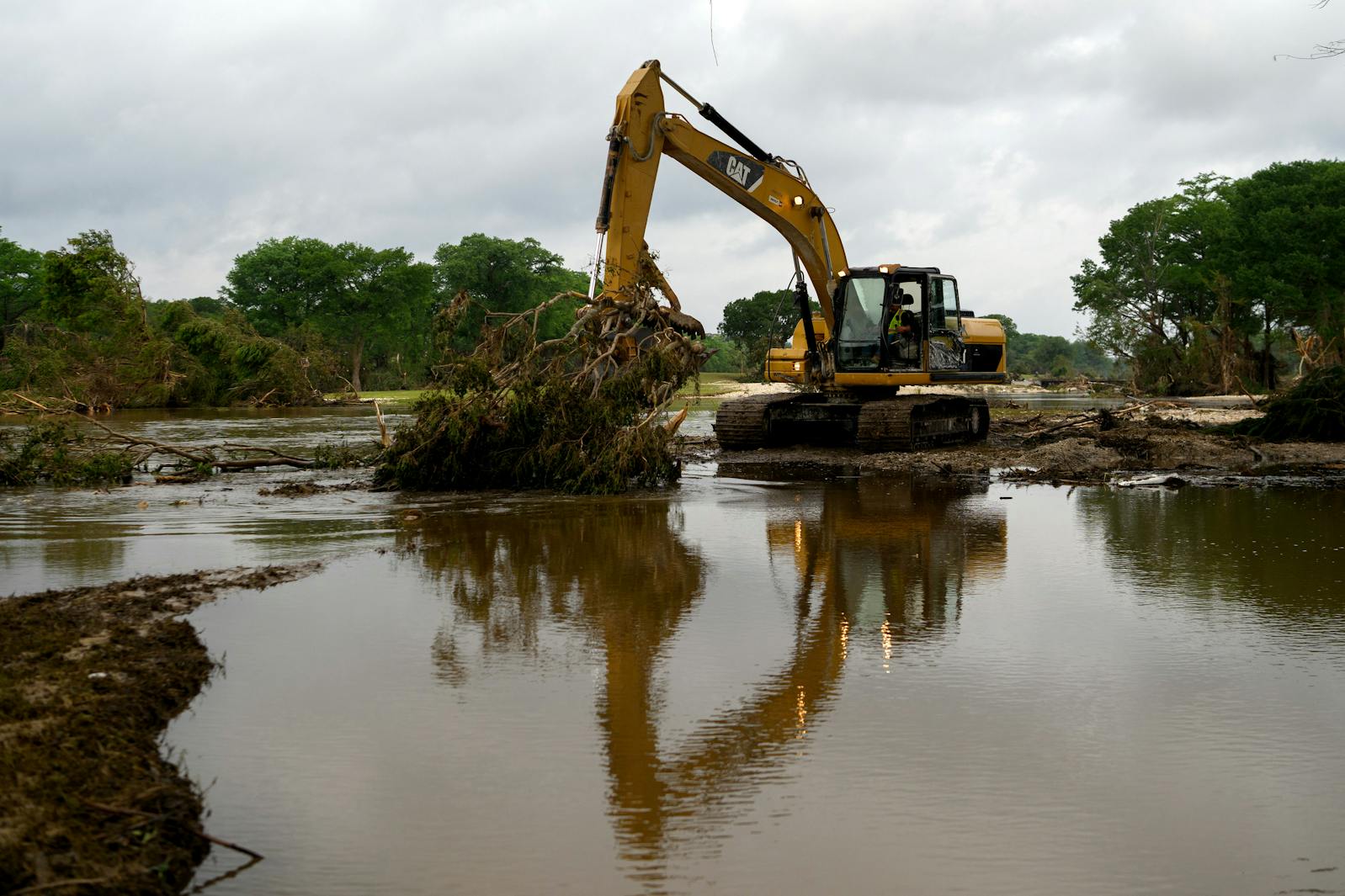 Flood debris is cleared in Kerrville, Texas, on Monday, July 7, 2025.  Camp Mystic, the all-girls Christian summer camp hit by the catastrophic flooding in Central Texas, confirmed on Monday that at least 27 campers and counselors had died.