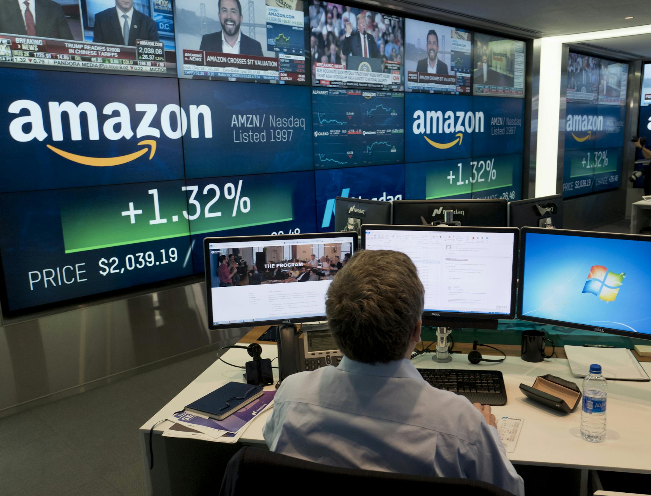 FILE- In this Sept. 4, 2018, file photo a Nasdaq employee monitors market activity in New York. Amazon.com Inc. reports earnings Thursday, Oct. 25. (AP Photo/Mark Lennihan, File) ORG XMIT: NYBZ426