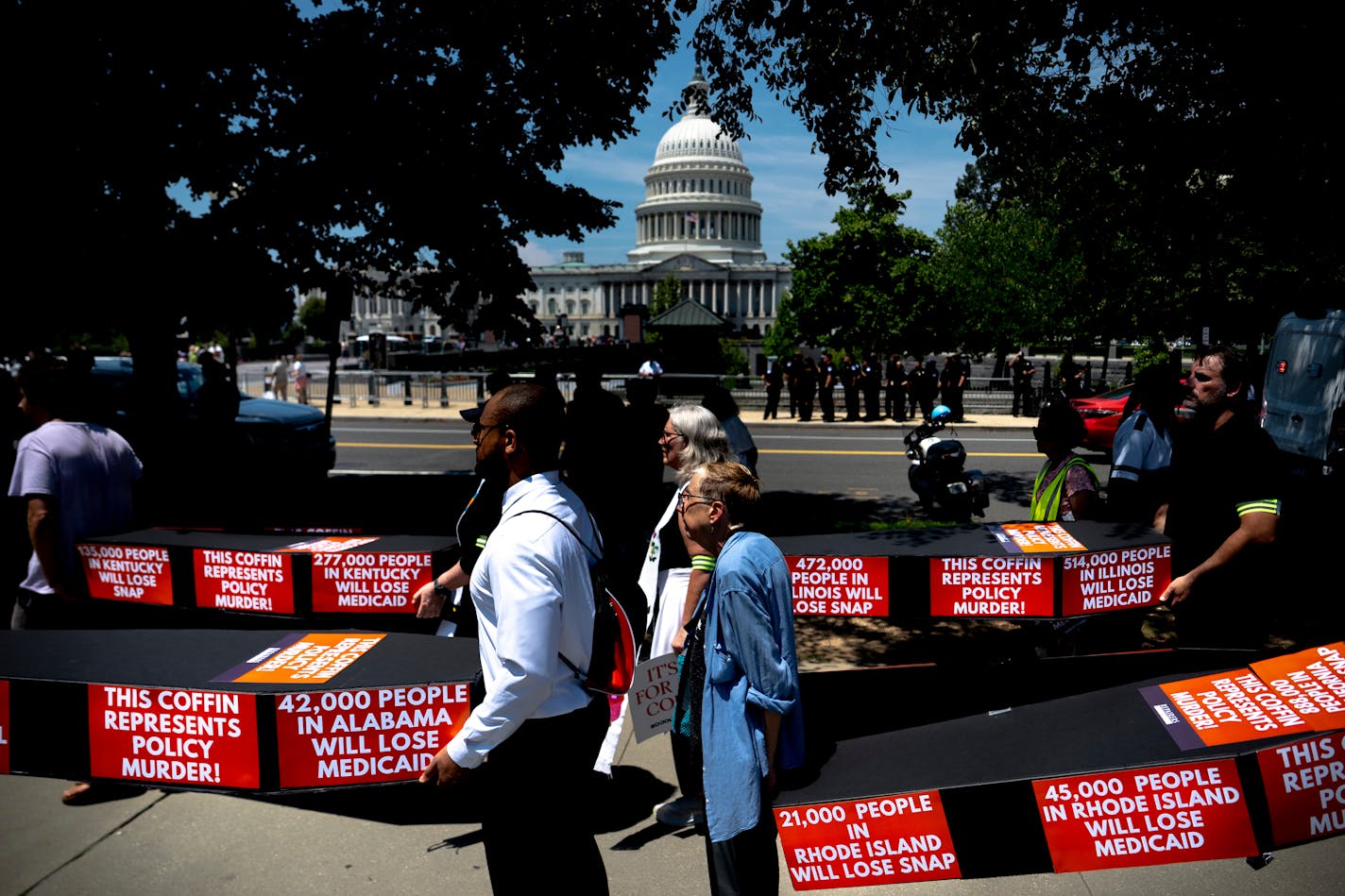 Demonstrators carry cardboard caskets in front of the U.S. Capitol in protest of President Donald Trump's tax breaks and spending cuts package on June 30 in Washington, D.C.