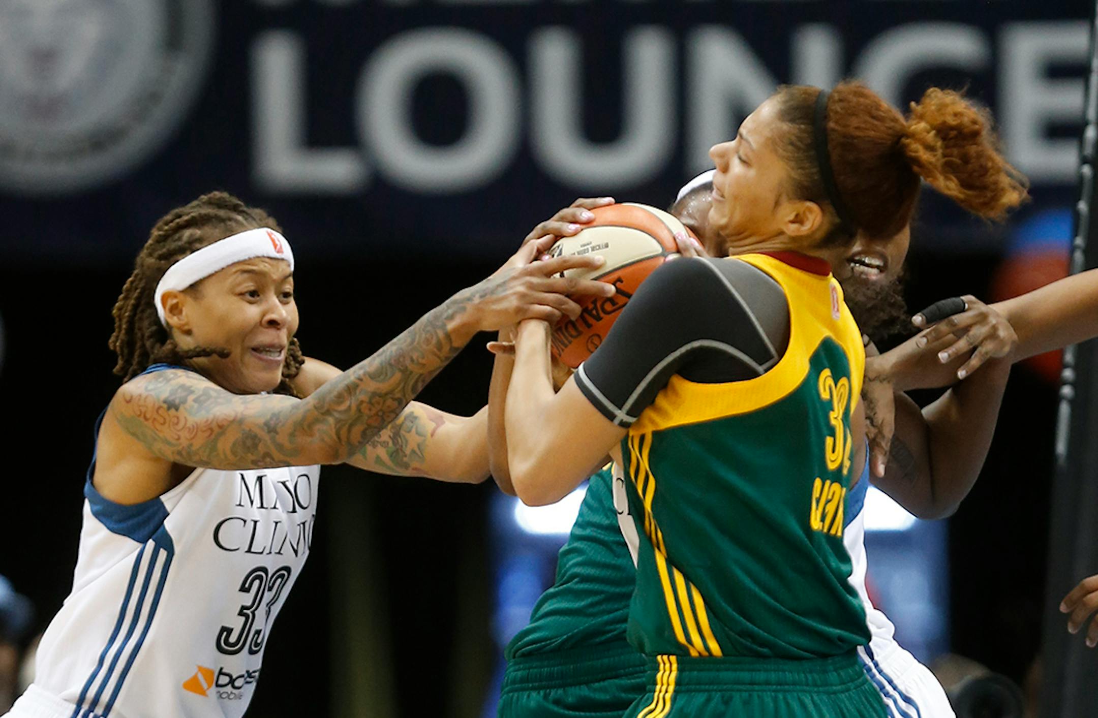 Lynx Seimone Augustus fought for the ball with Seattle's Alysha Clark during the first half.