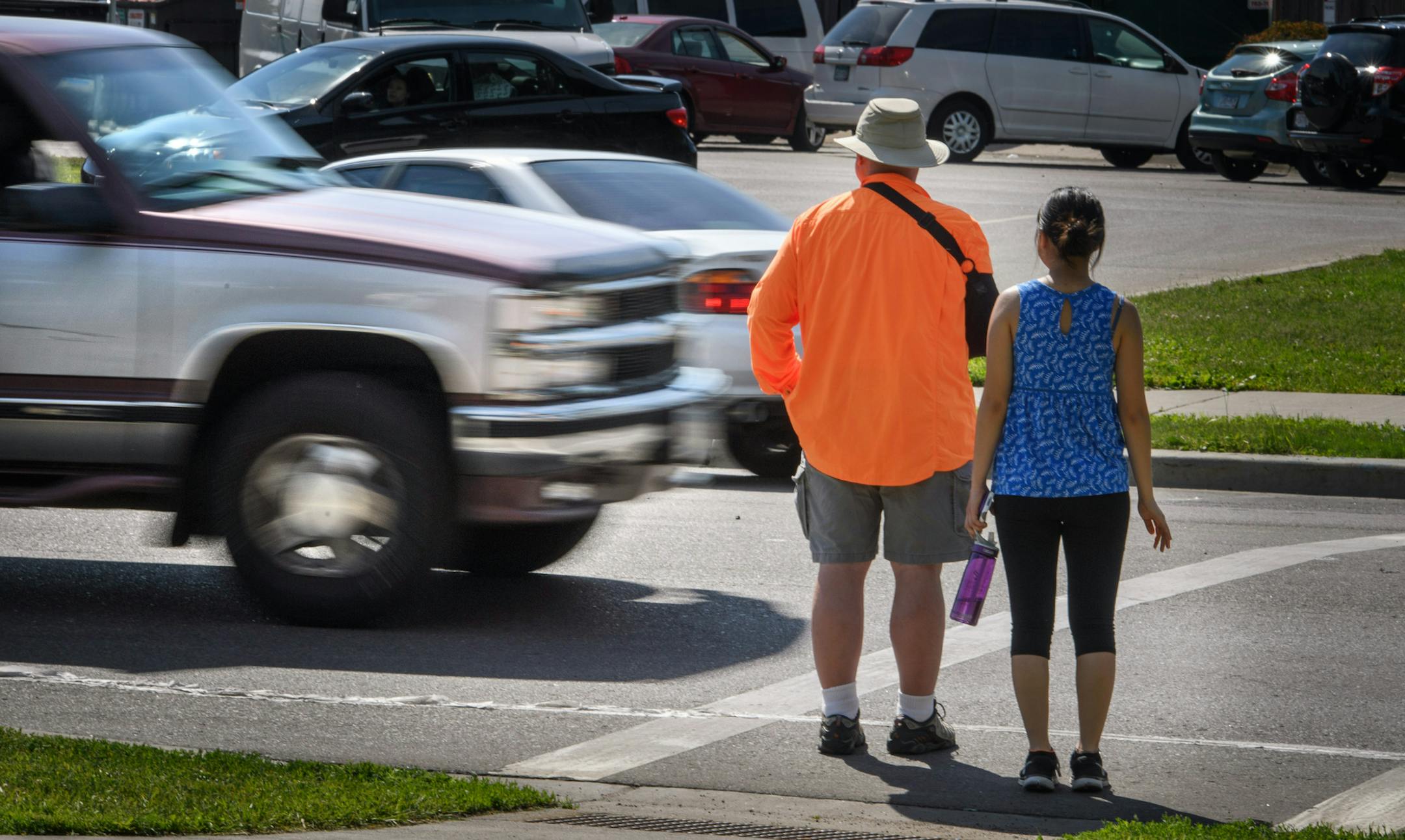 A maroon and silver truck drove through the marked crosswalk in front of pedestrian volunteers Dave Passiuk and Nelsie Yang. It was pulled over seconds later by St. Paul Police. ] GLEN STUBBE * gstubbe@startribune.com Wednesday, June 8, 2016, Volunteers from neighborhood groups working with StopForMe.org entered a marked pedestrian crosswalk at Johnson Parkway and Ames Ave on the East Side of St. Paul. If the vehicles violated the law they were pulled over by St. Saul Police. A day after yet ano