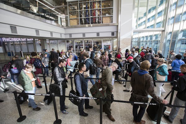 Passengers wait in line to go through the new north security checkpoint at Terminal 1 of Minneapolis-St. Paul International Airport.