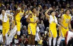 Players on the Gophers bench reacted to a basket by a teammate in the final minute of the game. Minnesota beat Nebraska by a final score of 88-73. ] C
