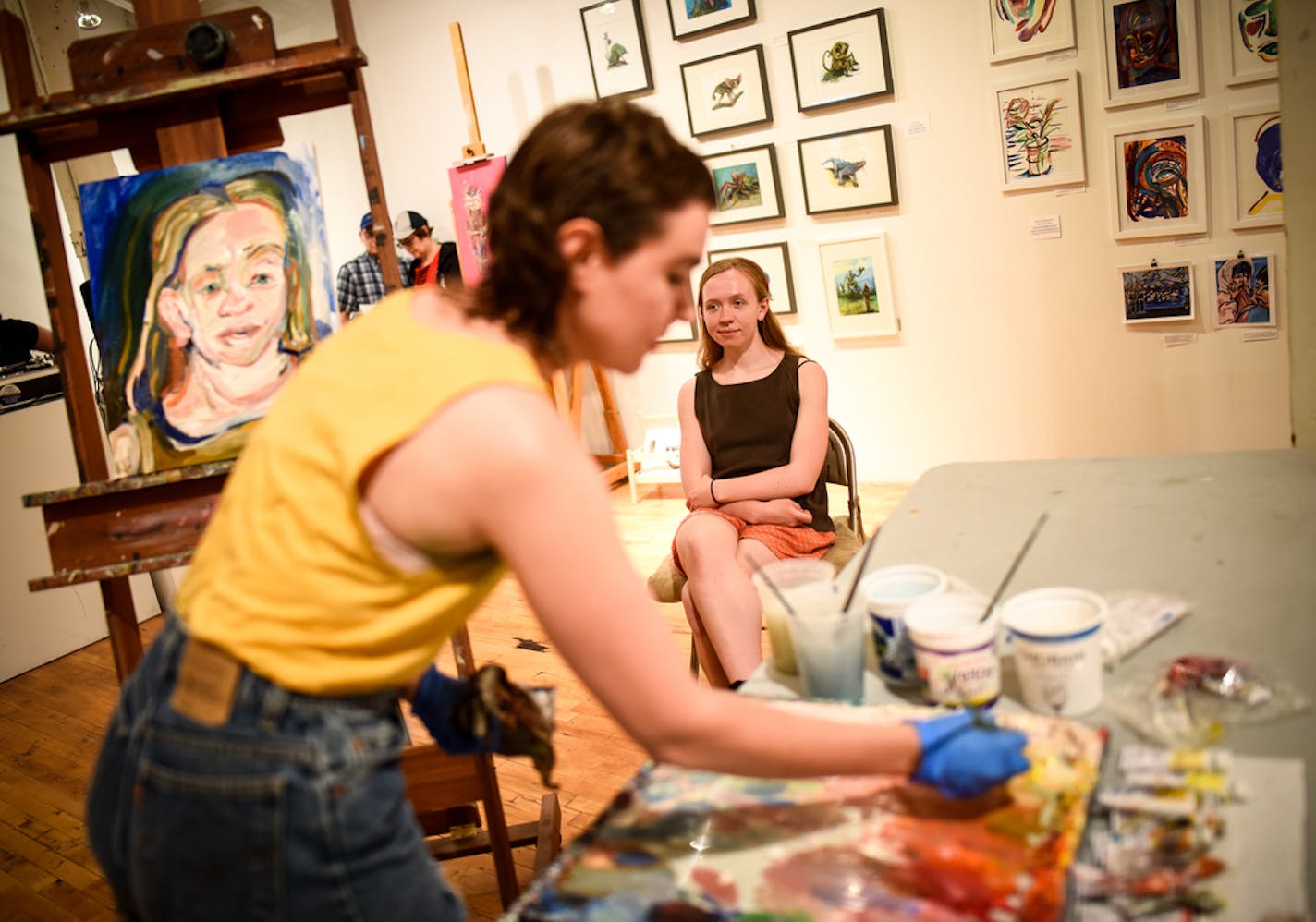 Artist Marlys Mandaville, of Minneapolis, used non-toxic, water-soluble oil paints to illustrate a portrait of her friend and former Macalester College classmate, Haley Ryan, during Art N|Motion Saturday at Art-A-Whirl in the Northrup King Building. "I love watching her process," said Ryan, who is an experienced model but first time subject for Mandaville. She's been sitting for the portrait for two hours, but Mandaville believes she'll be done in by three hours. ] AARON LAVINSKY &#x2022; aaron.