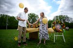 Tory Hart and fiancee Josie Josephson hold the urn containing the remains of slain 6-year old Eli Hart before releasing balloons during a celebration 