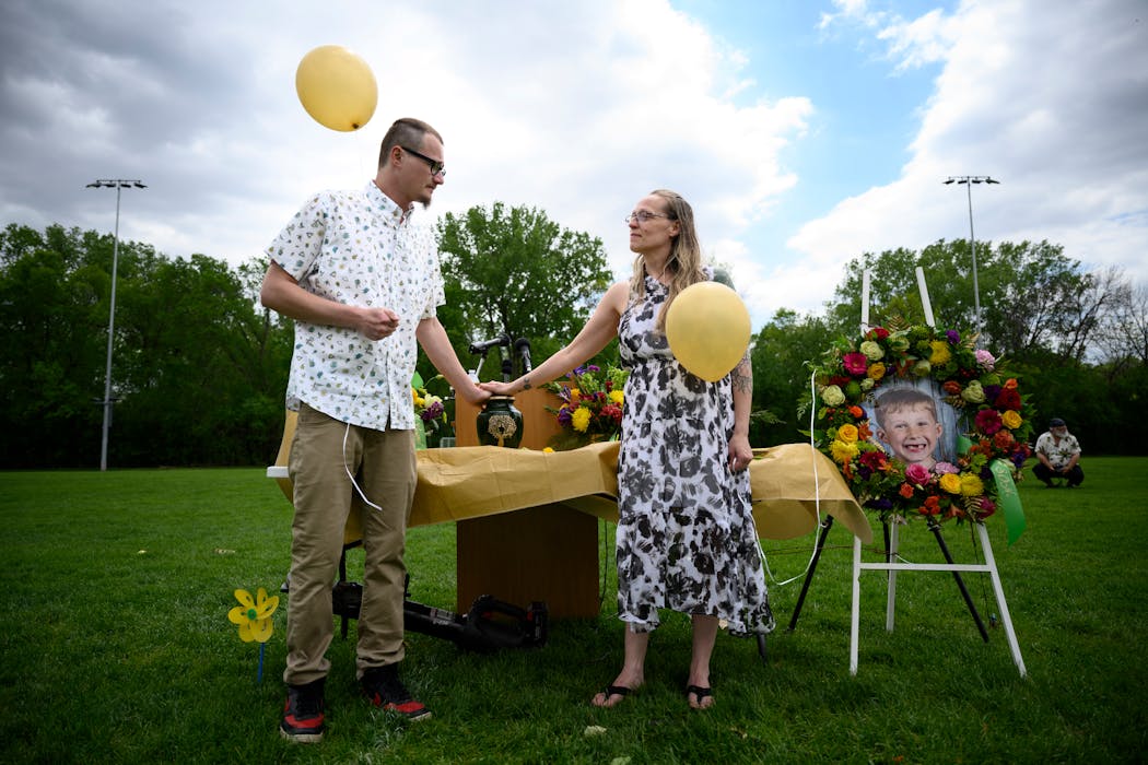 Tory Hart and fiancee Josie Josephson held the urn containing the remains of slain 6-year old Eli Hart before releasing balloons during a celebration of life for Eli at the Randolph High School football field Saturday, May 28, 2022 in Randolph, Minn.