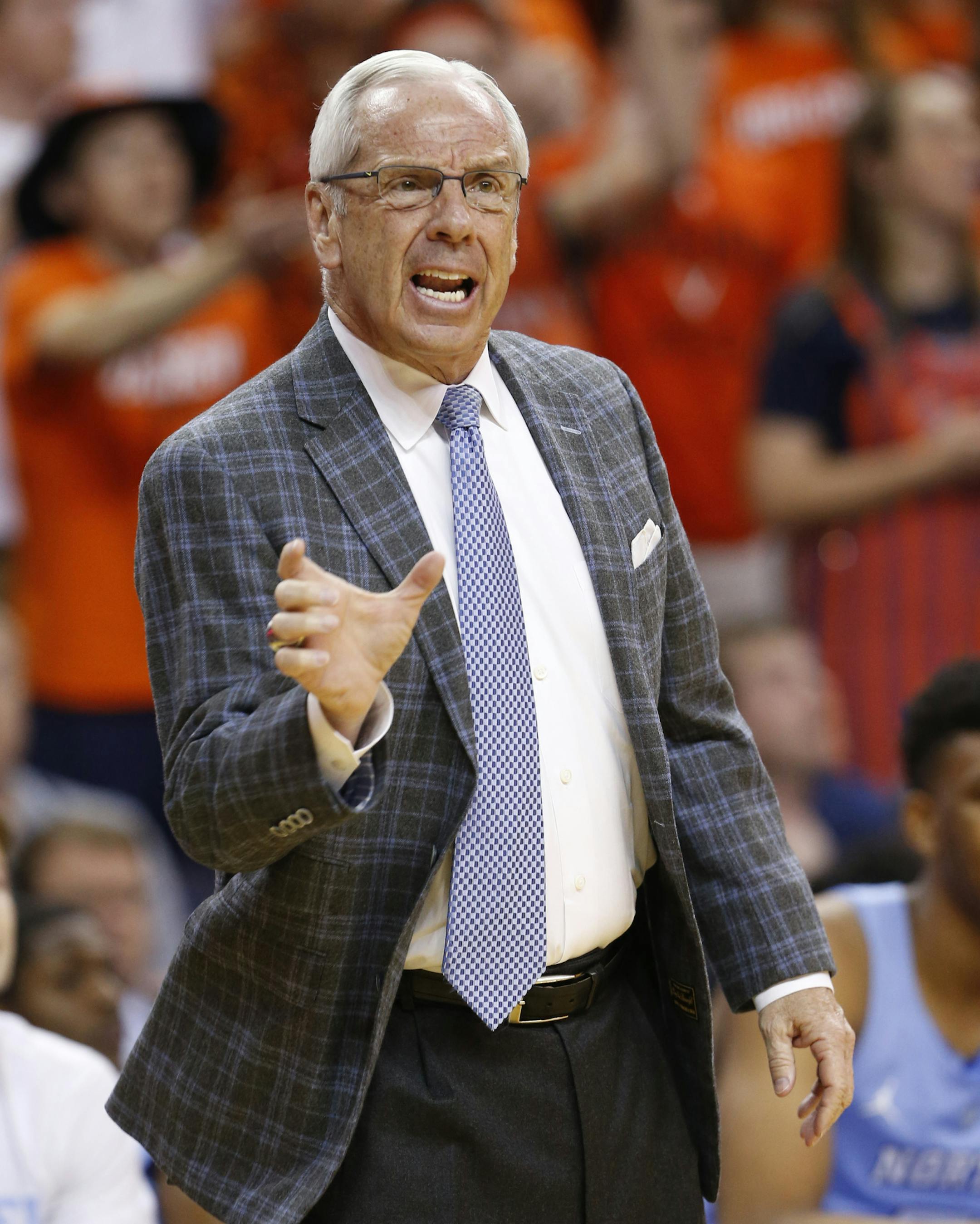 North Carolina head coach Roy Williams directs his team during the first half of an NCAA college basketball game against Virginia in Charlottesville, Va., Monday, Feb. 27, 2017. (AP Photo/Steve Helber)