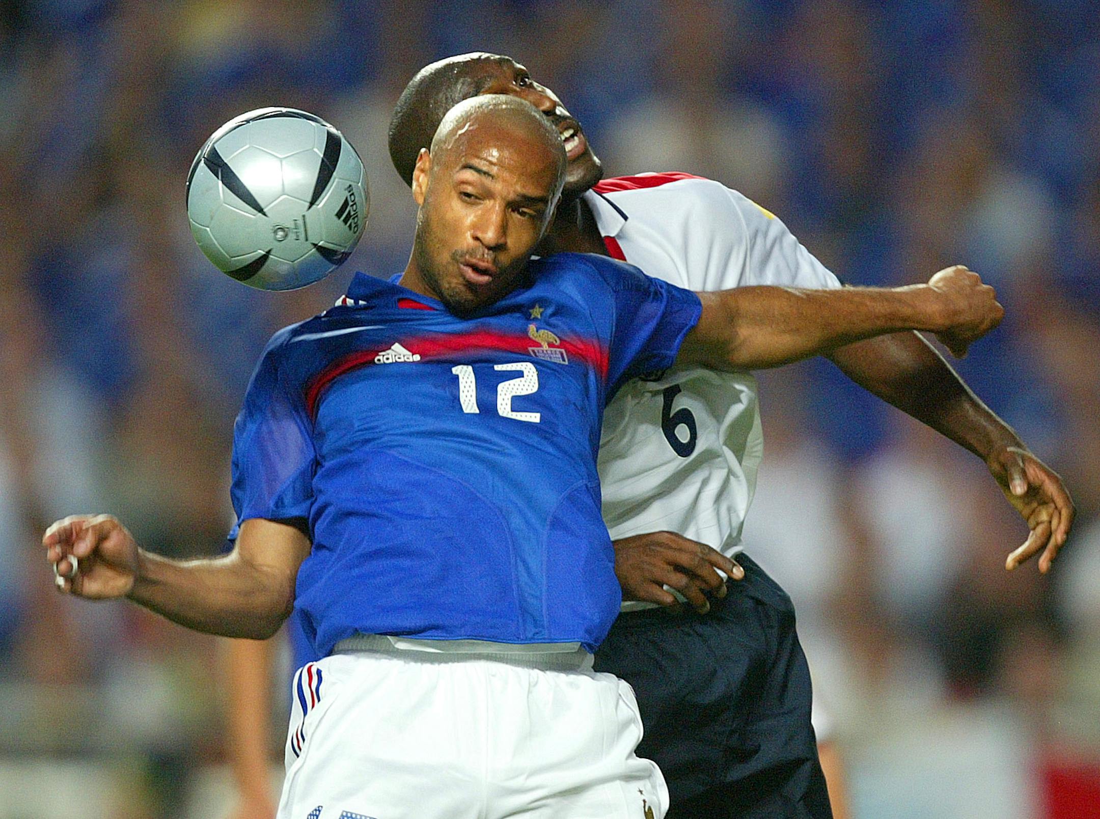 In this 2004 file photo, Thierry Henry, front, of France, was challenged by England's Sol Campbell during their Euro 2004 Group B soccer match at Luz Stadium in Lisbon, Portugal. Thierry Henry has announced his retirement following a 20-year career. The 37-year-old Henry, a member of the France teams that won the 1998 World Cup and 2000 European Championship, will take up a media role as a consultant for Sky Sports channel.
