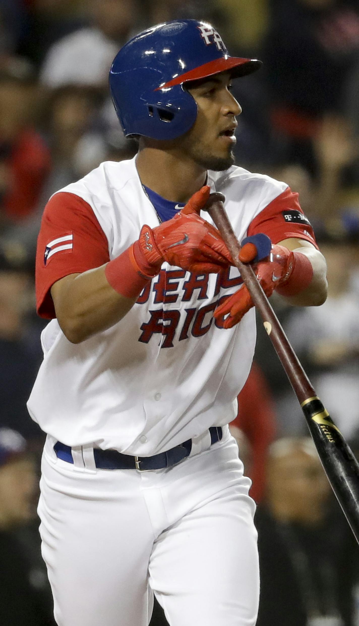 Puerto Rico's Eddie Rosario watches his game winning hit against the Netherlands in the 11th inning of a semifinal in the World Baseball Classic in Los Angeles, Monday, March 20, 2017. Rosario's sacrifice fly drove in Carlos Correa with the winning run in the 11th inning, giving Puerto Rico a 4-3 victory over the Netherlands on Monday night and a berth in the World Baseball Classic championship game. (AP Photo/Chris Carlson) ORG XMIT: LAD123