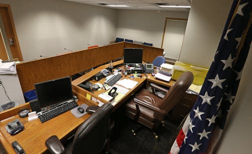 US Immigration Courtroom in Bloomington MN., photographed on 3/11/14. One by one, the realities of an overwhelmed immigration system came walking into the courtroom in handcuffs and prison-issue flip-flops, Judge William J. Dickerson, who has seen it all in 40 years, presiding. On one recent day in a windowless room with mismatched chairs and tired wood paneling of a basement man-cave, Dickerson, one of three U.S. Immigration Court judges in Minnesota, heard 22 cases of people being detained for