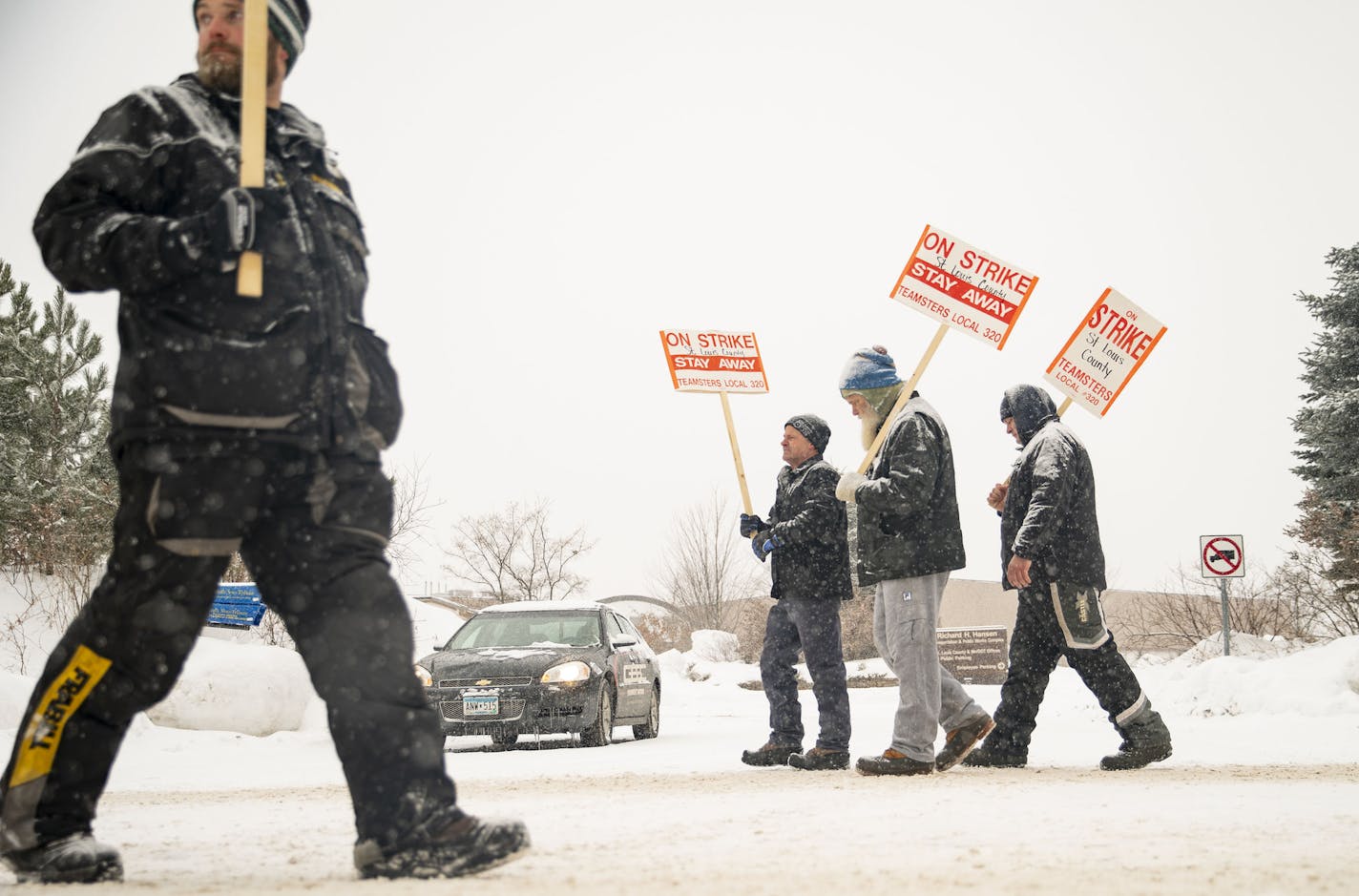 St. Louis County snow plow drivers picketed in front of the St. Louis County Public Works Department building in Northern Duluth, MN as snow fell on January 15, 2020. ]
ALEX KORMANN &#x2022; alex.kormann@startribune.com St. Louis County snow plow drivers went on strike starting on January 15, 2020. Picketers gathered at St. Louis County Public Works Department building in Pike Lake, MN starting around 7AM.