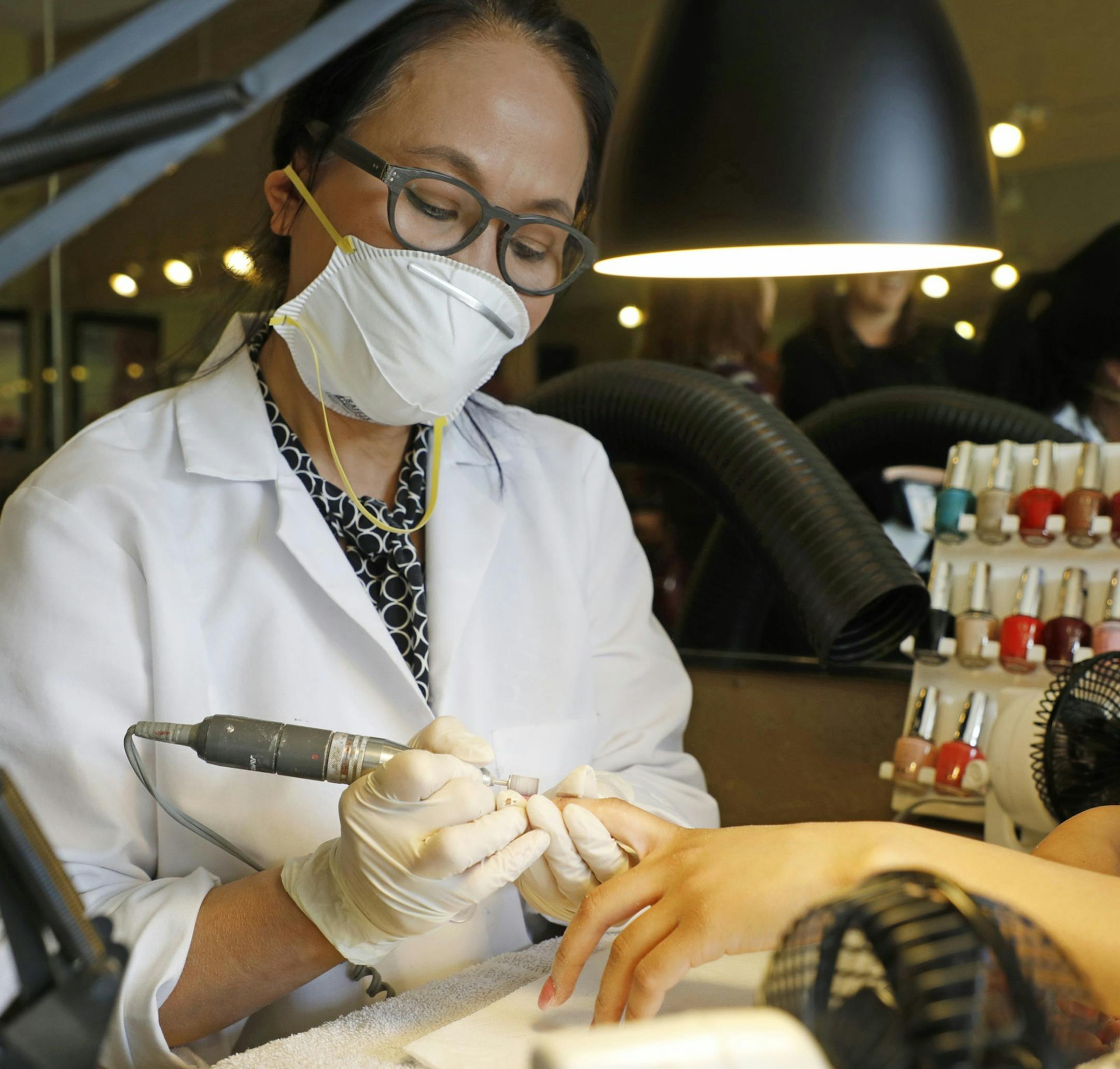 Owner of Leann's Nails Lan Anh Truong works on a customer's nails at her shop in Alameda, Calif., on Friday, April 27, 2018. Leann's Nail is part of the Healthy Nail Salon Collaborative, a program which helps salons switch products and add ventilation systems to improve working conditions. (Laura A. Oda/Bay Area News Group/TNS) ORG XMIT: 1230291