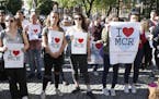 People gather ahead of a vigil in Albert Square, Manchester, England, Tuesday May 23, 2017, after a 23-year-old man was arrested in connection with Mo