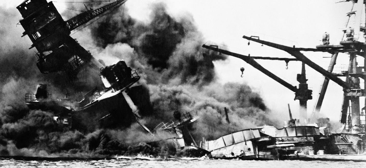 The battleship USS Arizona belches smoke as it topples over into the sea during Japanese surprise attack on Pearl Harbor, Hawaii, December 7, 1941. The ship sank with more than 80 percent of its 1,500-man crew, including Rear Admiral Issac C. Kidd. The attack, which left 2,343 Americans dead and 916 missing, broke the backbone of the U.S. Pacific Fleet and forced America out of a policy of isolationism. President Franklin D. Roosvelt announced that it was "a date which will live in infamy" and C