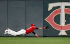 Twins right fielder LaMonte Wade Jr. dives for a ball that went for an RBI triple by Cleveland's Oscar Mercado