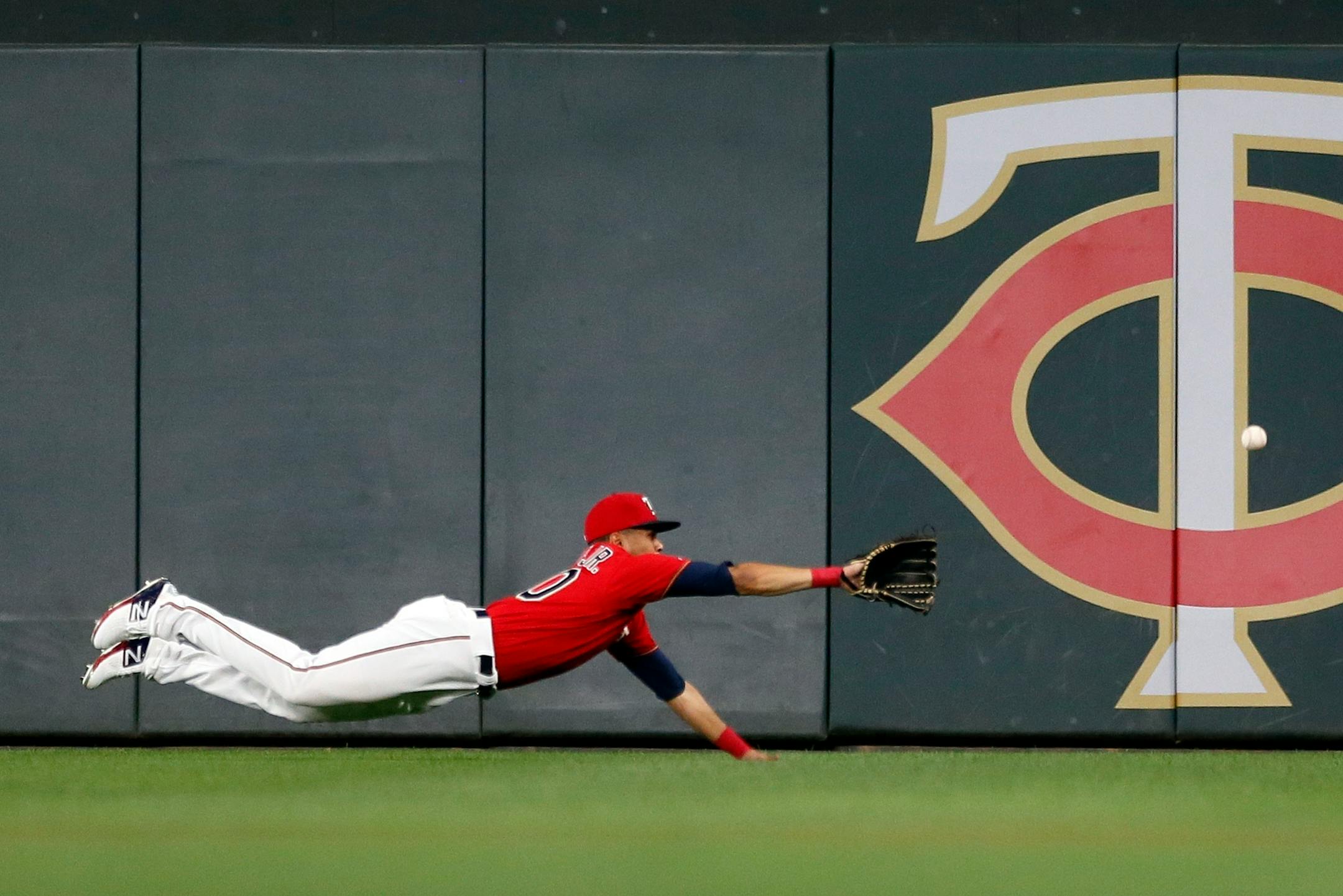 Twins right fielder LaMonte Wade Jr. dives for a ball that went for an RBI triple by Cleveland's Oscar Mercado