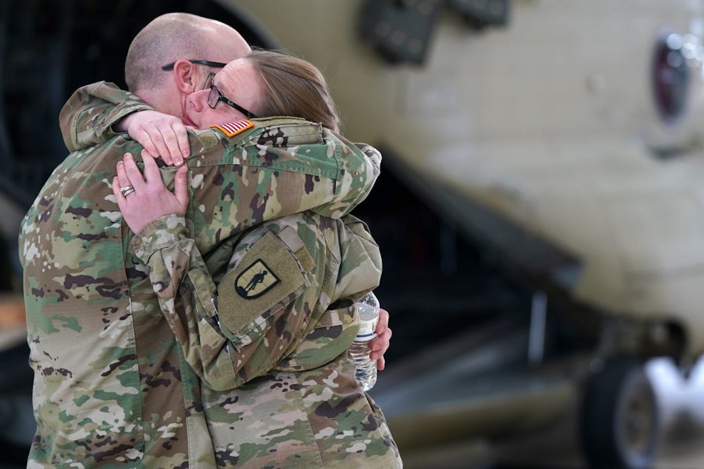 Maj. Nathan Burr and Lt. Col. Brandi Degier, who both knew the three deceased soldiers, comforted one another ahead of Saturday's press conference.