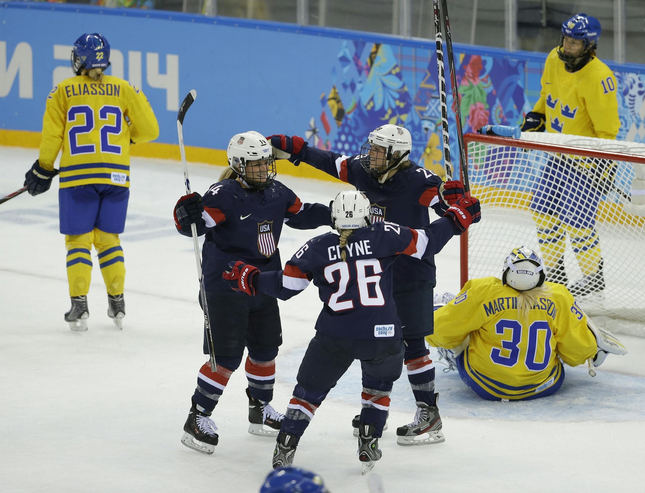 Brianna Decker of the United States (14), Kendall Coyne (26) and Amanda Kessel celebrate a goal by Decker against Sweden during the third period of the 2014 Winter Olympics women's semifinal ice hockey game at Shayba Arena, Monday, Feb. 17, 2014, in Sochi, Russia. The USA won 6-1.