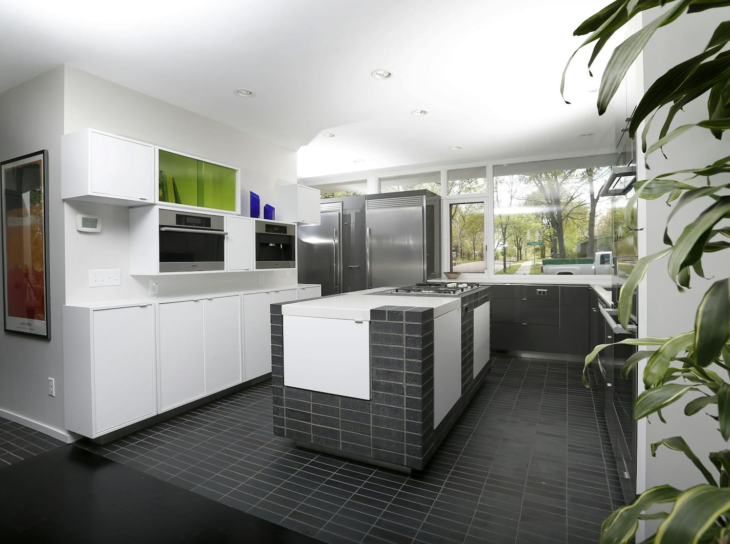 The remodeled kitchen island repeats the fireplace's stacked brick design.