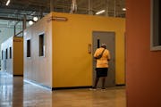 A staff member conducts a room check at Avivo Village in Minneapolis' North Loop neighborhood in September 2022.
