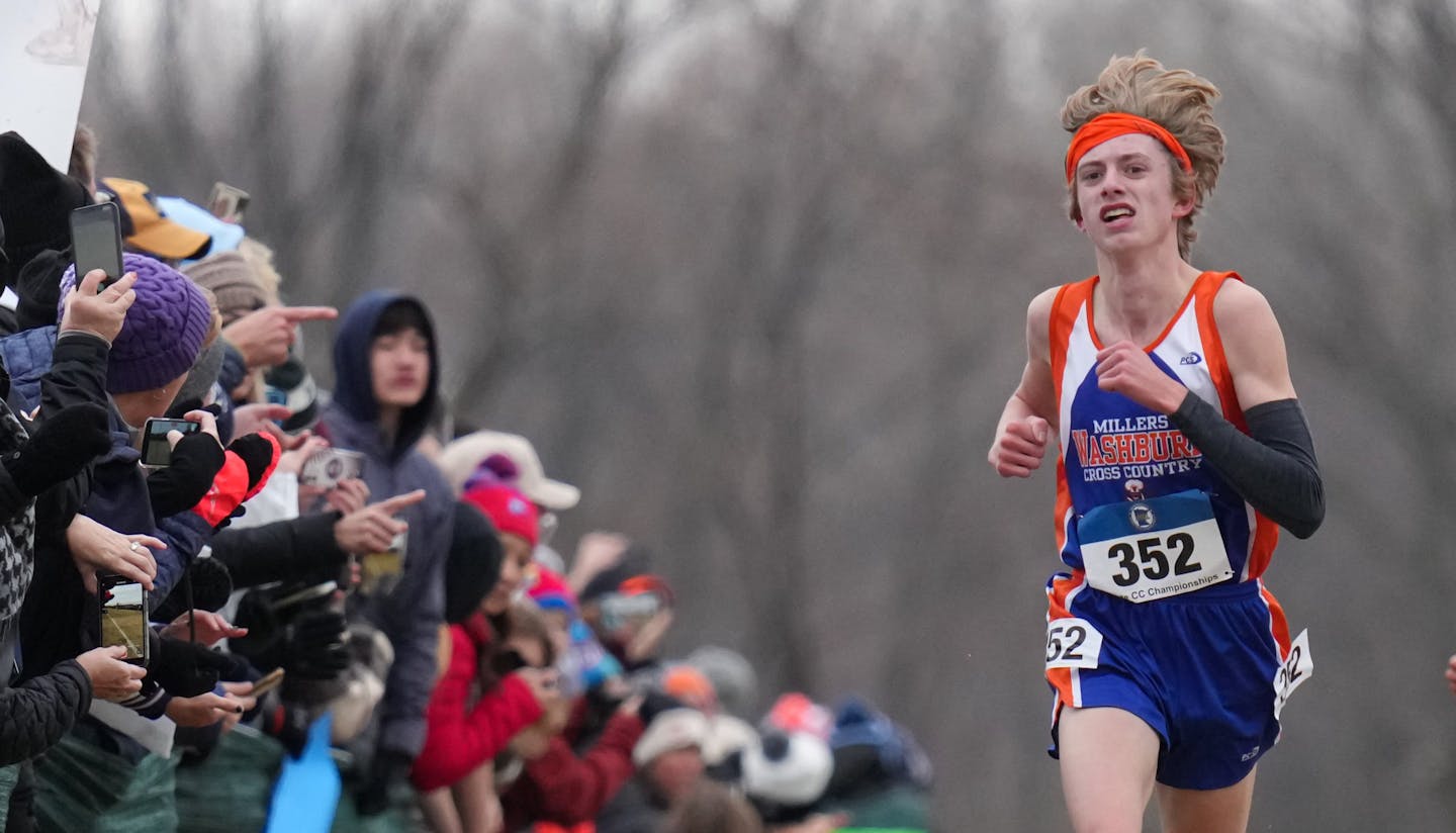 Aiden Jones, left, of Minneapolis Washburn won the boys 3A with a time of 15:11.73, behind is second place finisher Sam Scott, right, of Minneapolis Southwest, with a time of 15:15.30 They hugged right after the finish Saturday, Nov. 5, 2022 Northfield, Minn. Class 3A cross-country state championships. ] GLEN STUBBE • glen.stubbe@startribune.com