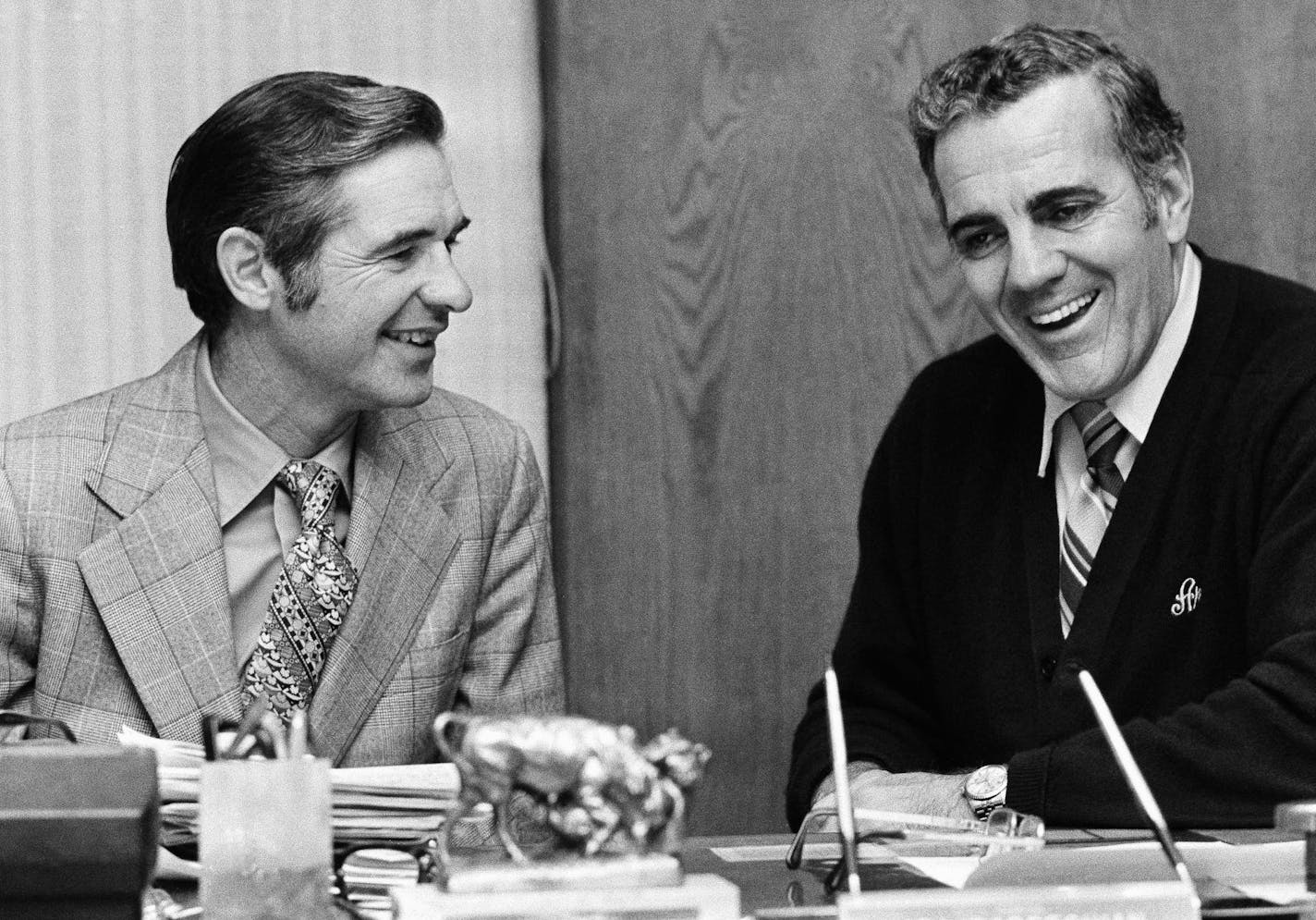 Dan Devine, left, former head coach of the Green Bay Packers, and Ara Parseghian, retiring head coach of Notre Dame University, go over transitional matters in Parseghian's office at South Bend, Dec. 17, 1974. Devine will succeed Parseghian at Notre Dame. (AP Photo/Charles Knoblock)