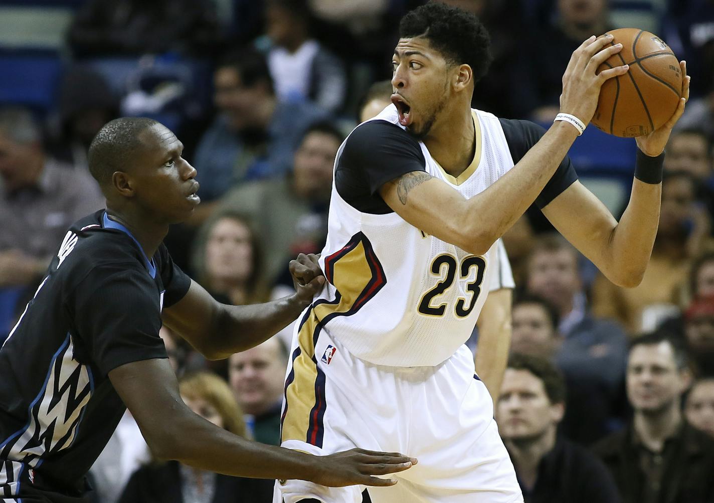 New Orleans Pelicans forward Anthony Davis (23) drives against Minnesota Timberwolves center Gorgui Dieng, left, during the first half of an NBA basketball game Tuesday, Jan. 19, 2016, in New Orleans. (AP Photo/Jonathan Bachman)