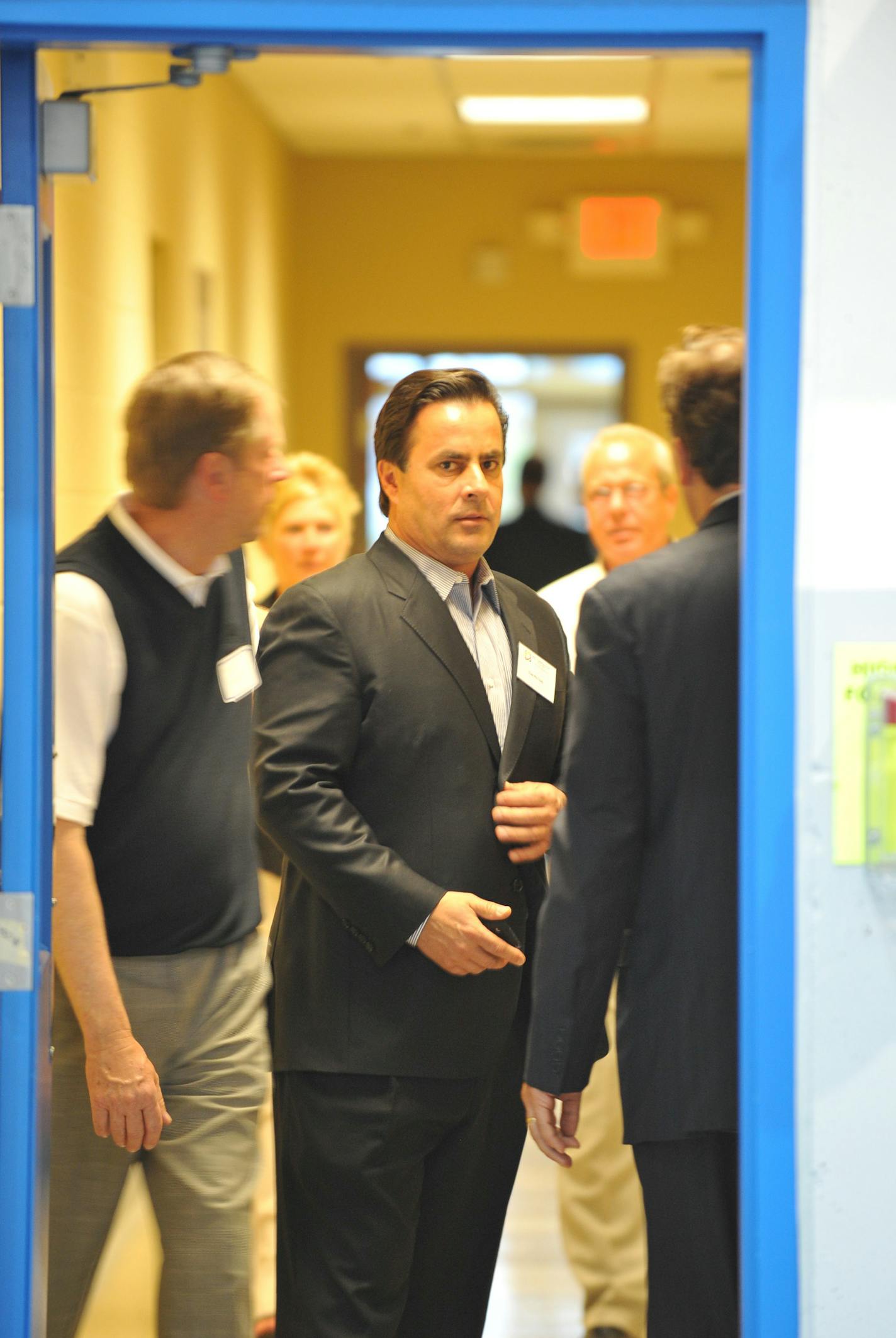 Tom Petters paused before entering his new Petters Aviation hangar. Petters then spoke to employees and invited guests at an open house for Petters Aviation at Minneapolis St. Paul International Airport.