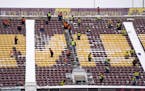 Workers cleared snow from the stands of TCF Bank Stadium after a snow storm. ] LEILA NAVIDI &#x2022; leila.navidi@startribune.com BACKGROUND INFORMATI