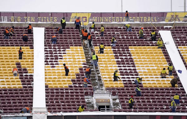 Workers cleared snow from the stands of TCF Bank Stadium after a snow storm. ] LEILA NAVIDI &#x2022; leila.navidi@startribune.com BACKGROUND INFORMATI