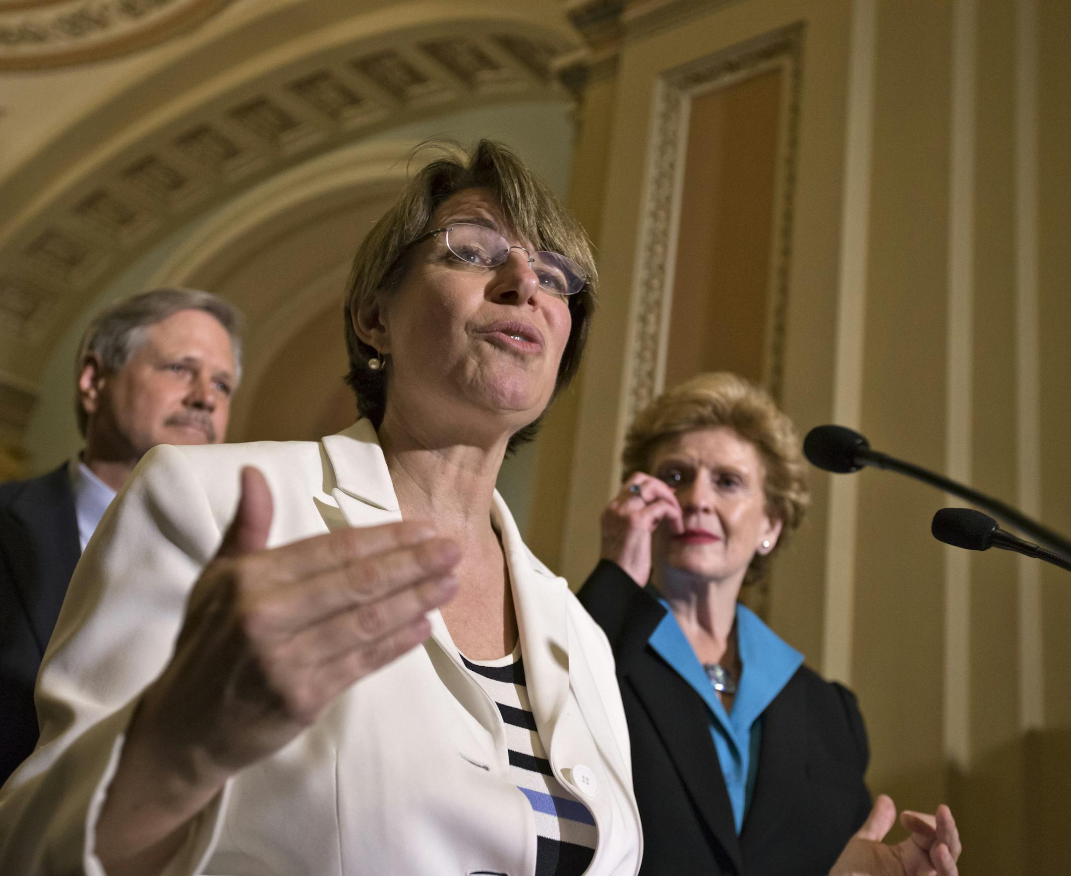 Sen. Amy Klobuchar, D-Minn., center, joins Sen. Debbie Stabenow, D-Mich., chairwoman of the Senate Agriculture Committee, right, and Sen. John Hoeven, R-ND, left, to speak to reporters as the Senate votes on a farm bill that sets policy for farm subsidies, food stamps and other farm and food aid programs for the next five years, at the Capitol in Washington, Monday, June 10, 2013. (AP Photo/J. Scott Applewhite) ORG XMIT: DCSA126