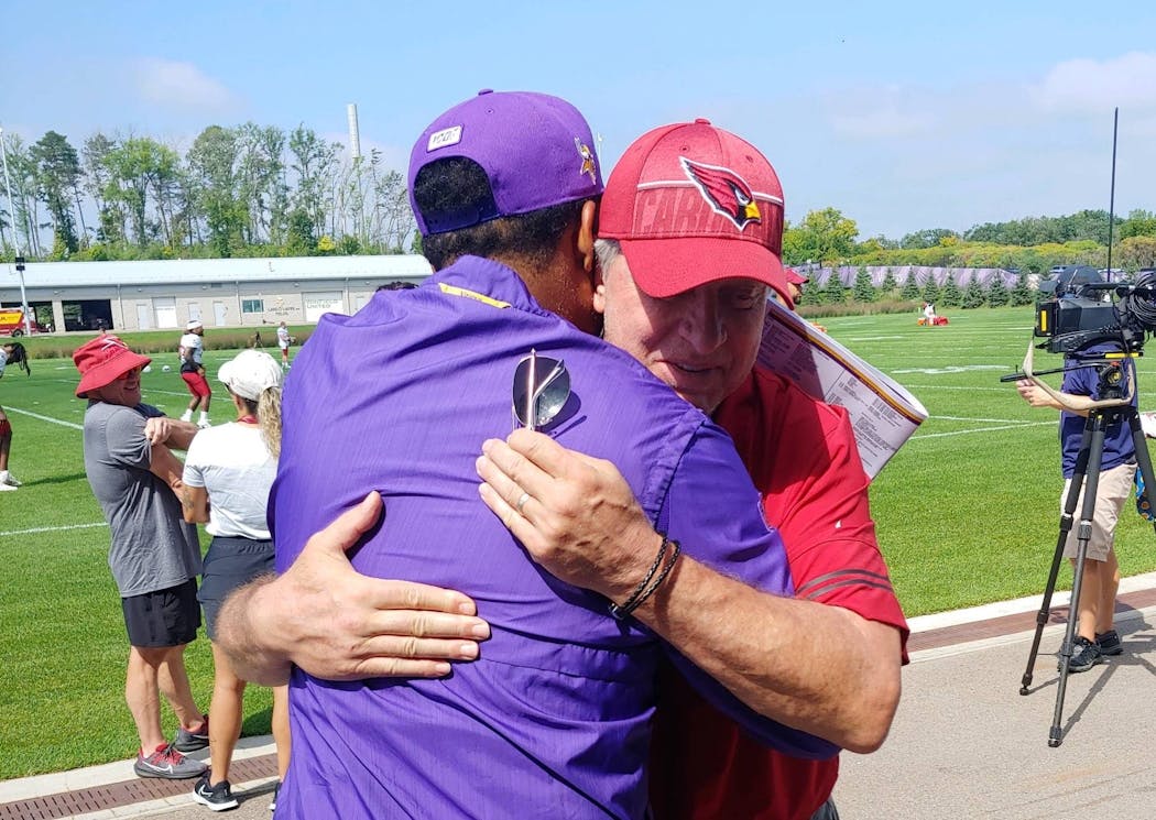 Vikings receivers coach Keenan McCardell greeted his former Browns teammate Ron Wolfley, who is now a Cardinals radio analyst.