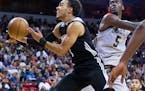 Timberwolves guard Tyus Jones sliced to the basket past Bulls forward Bobby Portis during the Summer League championship game in Las Vegas on Monday. 