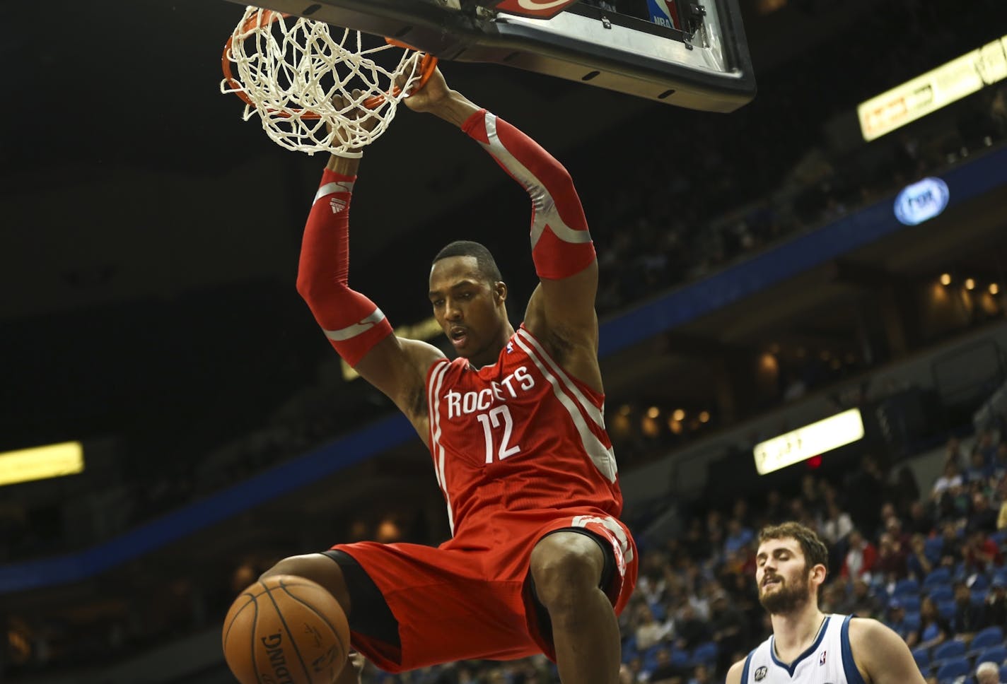 Rockets' Dwight Howard dunked the ball as Timberwolves Kevin Love watch behind him during the second half of an NBA basketball game between the Minnesota Timberwolves and the Houston Rockets Monday, February 10, 2014 at the Target Center in Minneapolis, Minn. The Timberwolves lost 107-89.