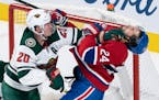 Phillip Danault is taken out from in front of the Wild's net by defenseman Ryan Suter