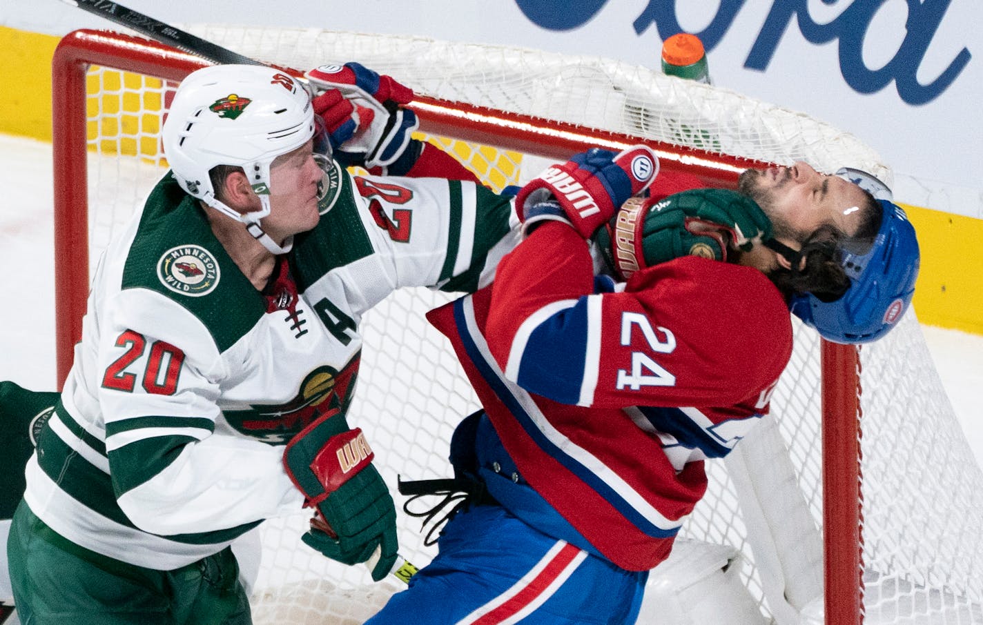 Phillip Danault is taken out from in front of the Wild's net by defenseman Ryan Suter