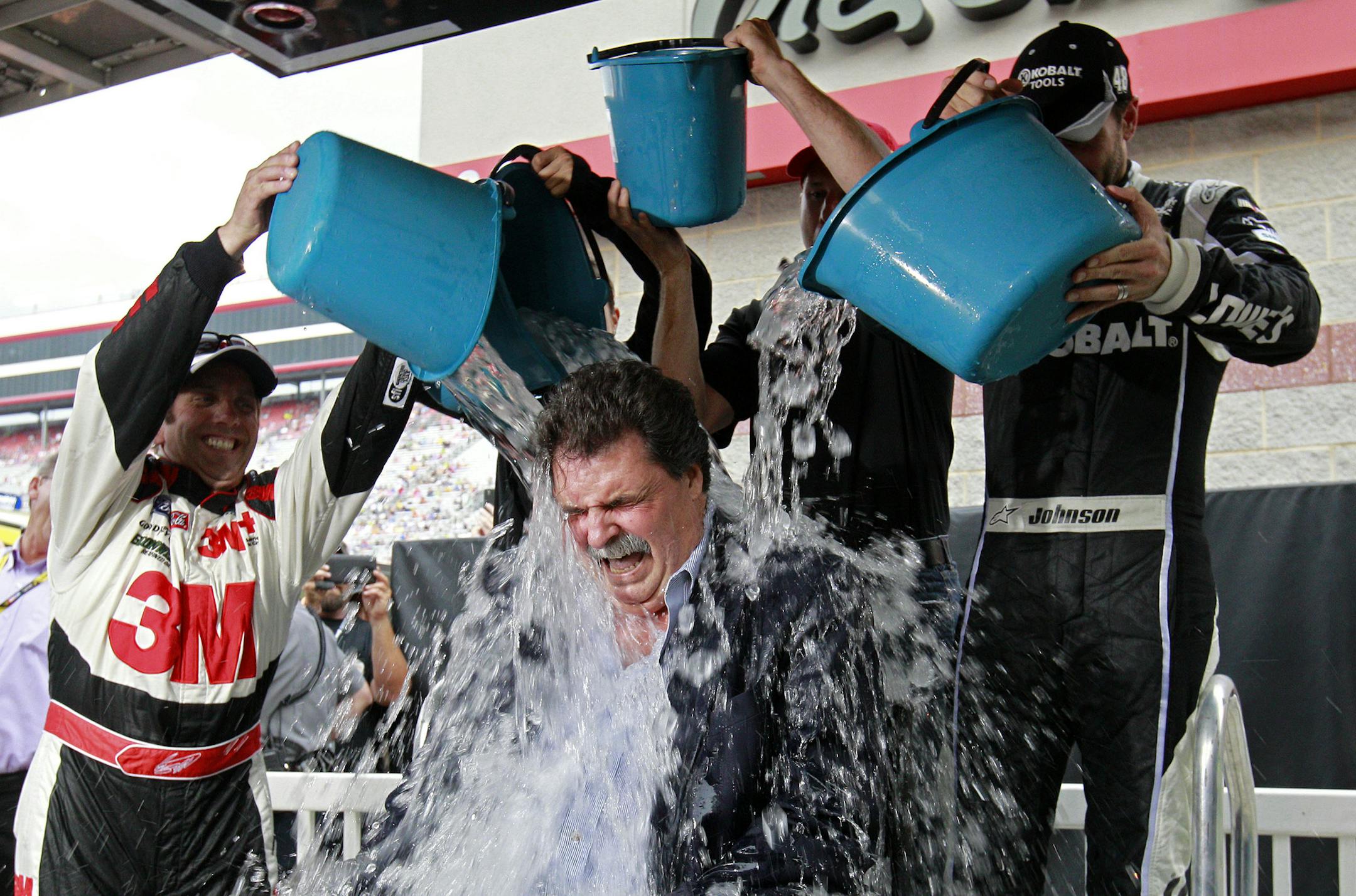 FILE - In this Aug. 22, 2014 file photo, NASCAR President Mike Helton has buckets of ice water dumped on him by drivers Greg Biffle, left, Danica Patrick, Jamie McMurry and Jimmie Johnson as part of the Ice Bucket Challenge to raise money for ALS, at Bristol Motor Speedway in Bristol, Tenn. The ALC Ice Bucket Challenge placed fifth on Google's list of 2014's fastest-rising global search requests, the company said Tuesday, Dec. 16, 2014. (AP Photo/Wade Payne, File)