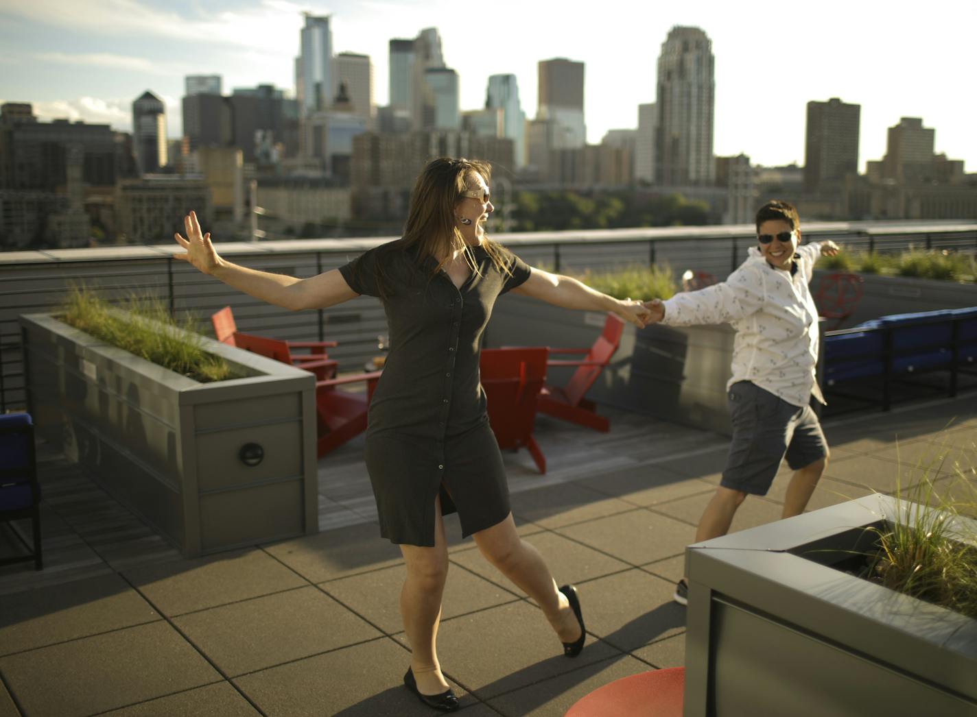 Maryrose Dolezal and Roya Moltaji, right, danced to Van Morrison's "Moondance" after drinks on the rooftop with friends who live at the A-Mill Artist Lofts, part of the Minneapolis riverfront housing boom.