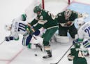 Wild goalie Alex Stalock (32) makes the save as Tanner Pearson (70) and Ryan Suter (20) battle for the rebound