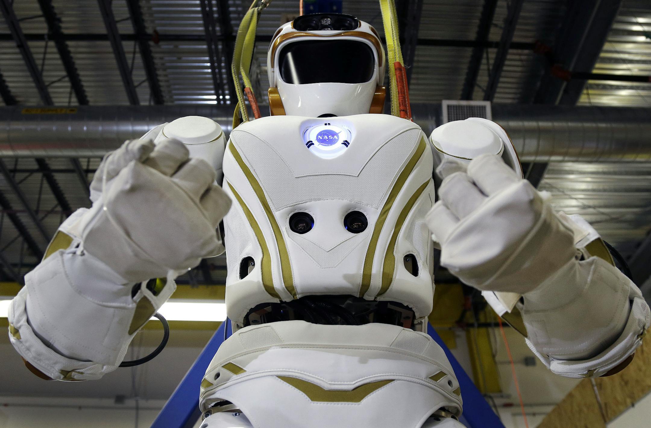 In this May 2, 2016 photo, a six-foot-tall, 300-pound Valkyrie robot is seen at University of Massachusetts-Lowell's robotics center in Lowell, Mass. "Val," one of four sister robots built by NASA, could be the vanguard for the colonization of Mars by helping to set up a habitat for future human explorers. But first they’re finding new homes on Earth and engineers to hone their skills. (AP Photo/Elise Amendola)