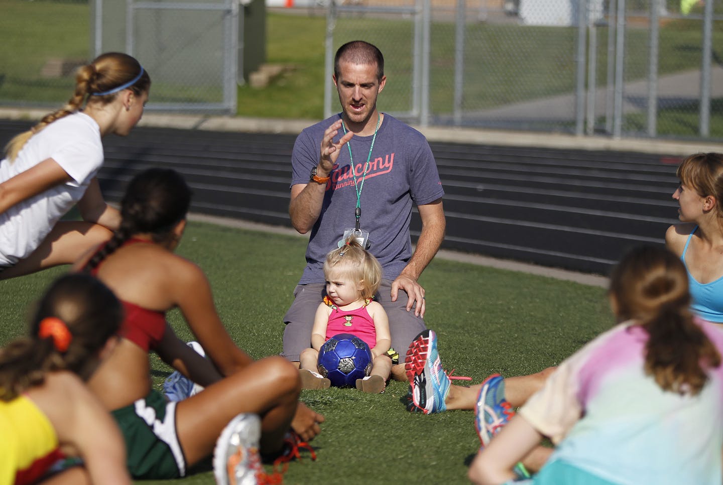 The Edina girls cross-country coach Matt Gabrielson, with his daughter Doris May, meeted with the team early Friday at the Edina Community Center, August 16, 2013 in Edina, MN. The team finished third in the Class 2A state meet in 2012. A strong freshman class and the return of junior Shannon Spalding, far right, who was 9th last year, make Edina a legit contender for a state title. (ELIZABETH FLORES/STAR TRIBUNE) ELIZABETH FLORES &#x2022; eflores@startribune.com