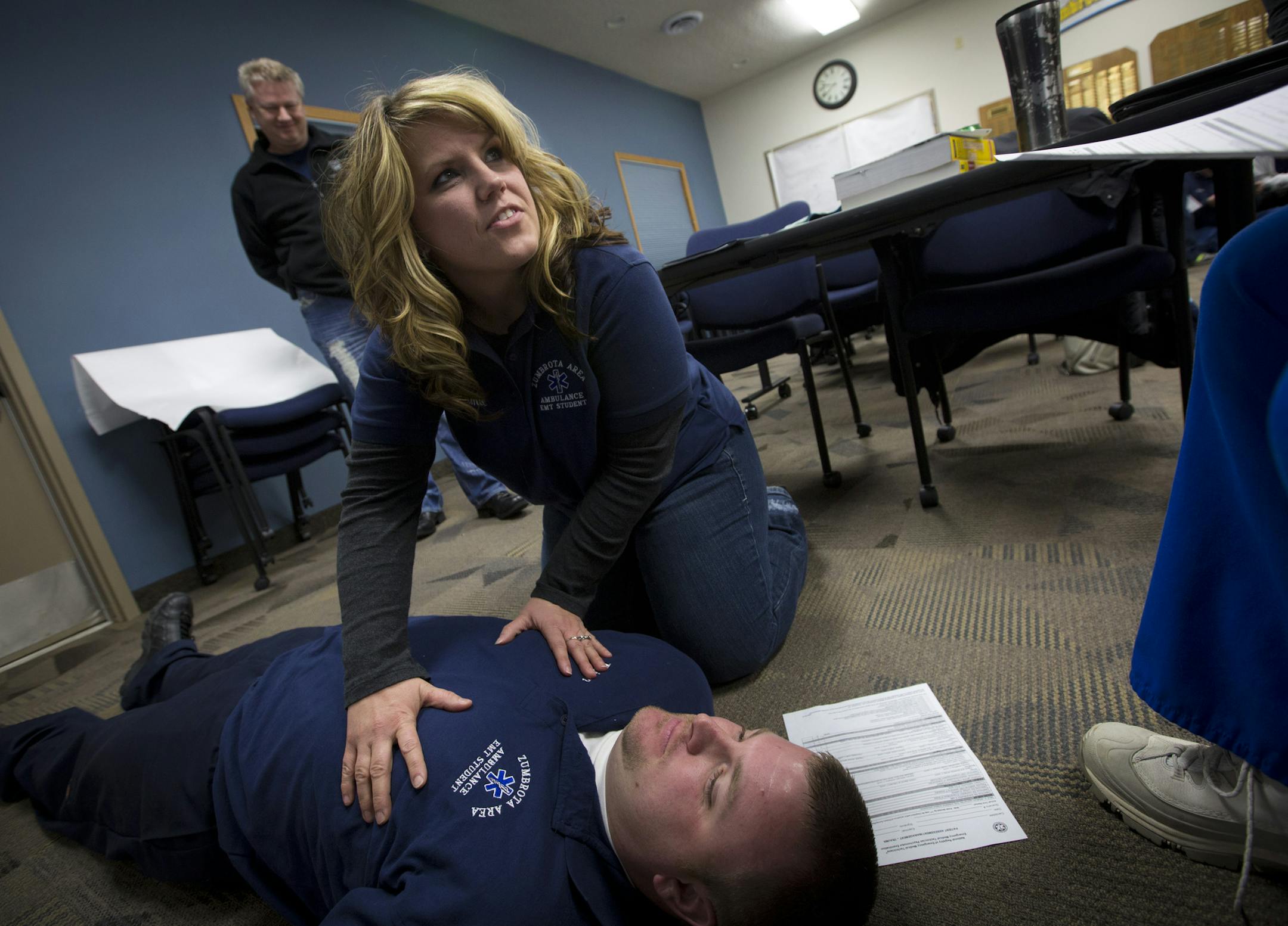 Jamie Sommers, 34, of Wanamingo did a training exercise on her partner Brian Radke during a EMS training class on Thursday, February 13, 2014 in Zumbrota, Minn. Some outstate volunteer EMS services are struggling to get and keep people while the population is aging and will need them more than ever.] (RENEE JONES SCHNEIDER reneejones@startribune.com)