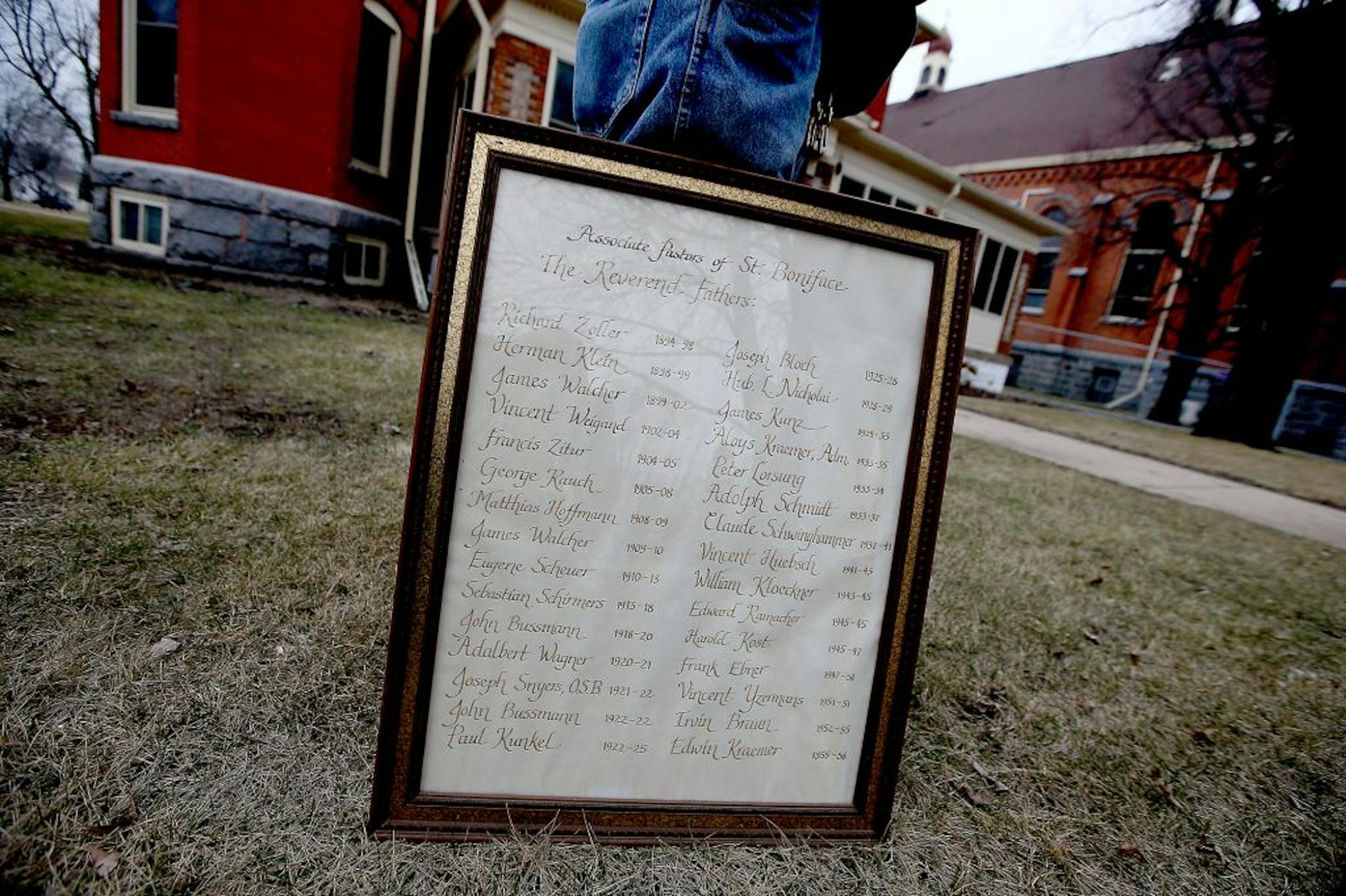 St. Mary's Catholic Church janitor Allan Wichmann, cq, tried to figure out where to place some historic frames that were recovered Friday, Monday, March 14, 2016 in Melrose, MN.