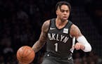 Brooklyn Nets guard D'Angelo Russell handles the ball during the first half of an NBA basketball game against the Boston Celtics, Saturday, March 30, 
