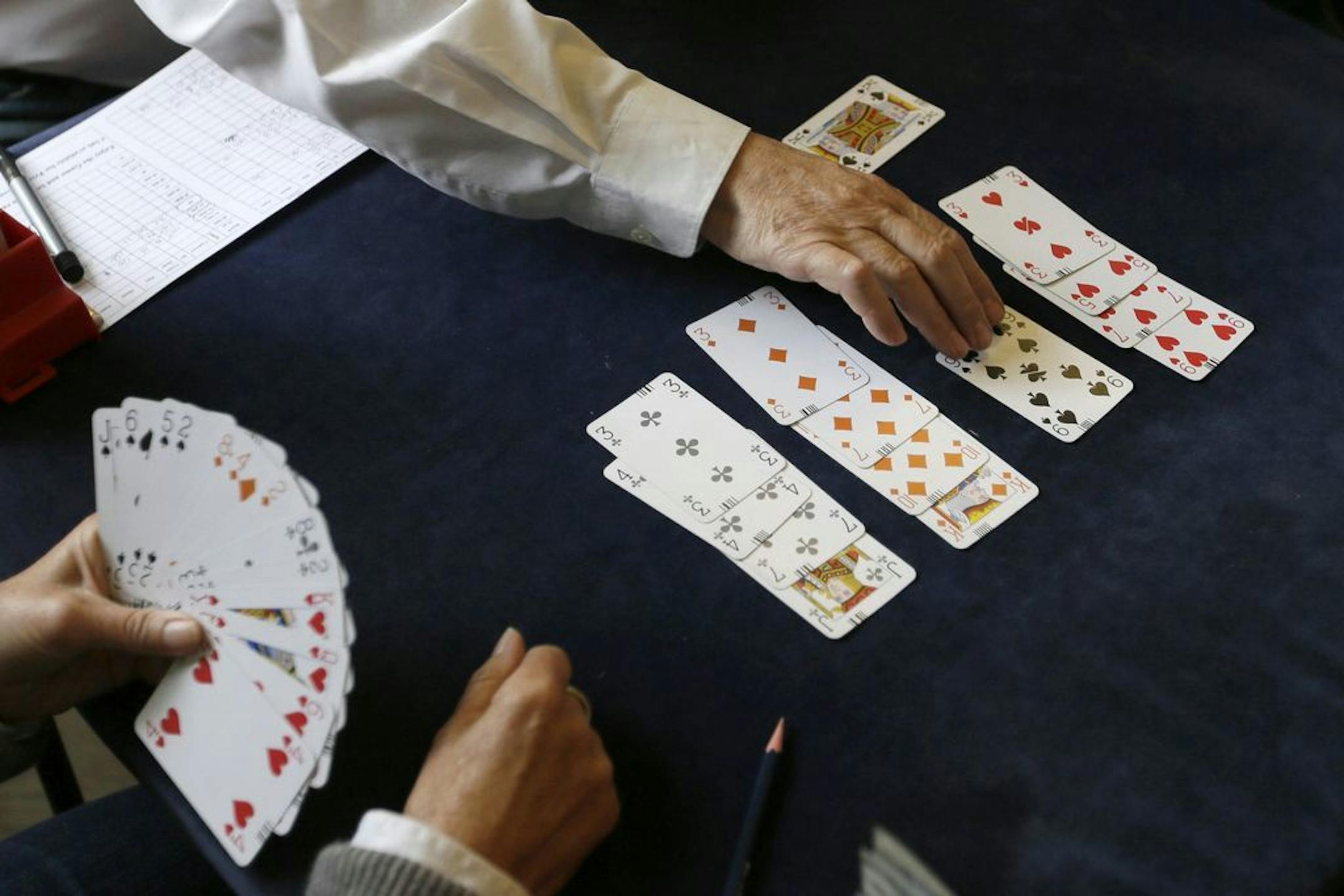 FILE - In this Tuesday, Sept. 22, 2015 file photo, competitors play bridge at the Acol Bridge Club in West Hampstead, London. A doping ban handed down to the top-ranked player in bridge has provoked a backlash in the card game. It also has provoked criticism of bridge's affiliation with the Olympics.